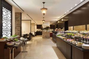 a restaurant with a buffet of food on display at Ramada Hotel & Suites by Wyndham Ajman in Ajman 