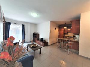 salon i kuchnia z kanapą i stołem w obiekcie Cristi Puerto Santiago Apartment by HRTenerife Net w mieście Puerto de Santiago