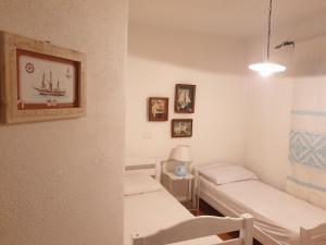 a hospital room with two beds and a window at Capo Figari 9, appartamento a Golfo Aranci in Golfo Aranci