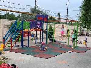 a group of children playing in a playground at SV apartments in Zatoka