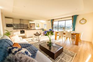 a living room with a couch and a table at Tekapo Space Apartment in Lake Tekapo