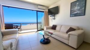 a living room with a couch and a glass table at Albufeira, Sea View (25) in Albufeira
