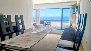 a dining room with a table and a view of the ocean at Albufeira, Sea View (25) in Albufeira