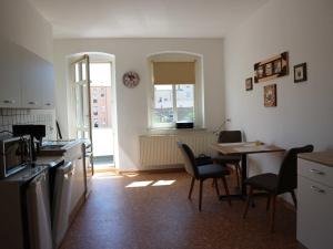 a kitchen and dining room with a table and chairs at Ferienwohnung MIWE Gesundheitszent in Forst