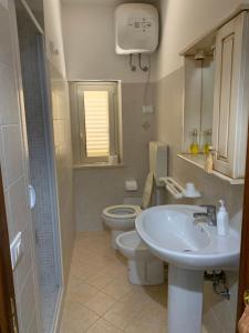 a bathroom with a sink and a toilet at Perla Marina in Trappeto