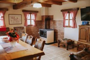 a living room with a fireplace and a table and chairs at Manuela in Gospić