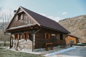 a small wooden cabin with a brown roof at Manuela in Gospić