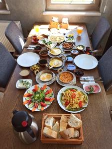 a wooden table with plates of food on it at Kaya Life Resort in Uzungöl