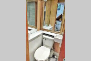 a bathroom with a toilet and a sink at Cute & Cosy Loft-Style Studio close to Beach in Bournemouth
