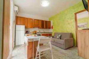 a kitchen with a table and a couch in a room at Via San Giacomo Primo piano in Ustica +6 photos