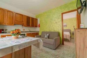 a kitchen with a couch and a living room at Via San Giacomo Primo piano in Ustica