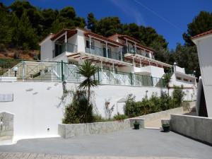 a large white house with a balcony at Villa Teozenia in Achladies