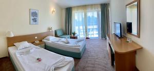 ソゾポルにあるDuni Belleville - All Inclusiveのベッド2台とテレビがあるホテルの部屋