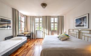 Postel nebo postele na pokoji v ubytování Hotel Hofgarten Luzern