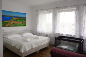 A bed or beds in a room at Apartmány Pemag Mikulov
