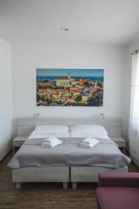 A bed or beds in a room at Apartmány Pemag Mikulov