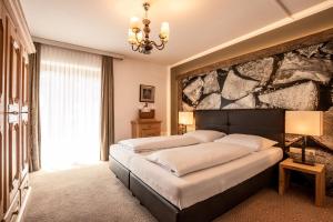 Łóżko lub łóżka w pokoju w obiekcie Hotel Hochfilzer