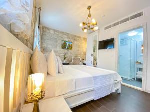 a bedroom with a large white bed and a window at PROVENCE MANSİON ALAÇATI in Alacati