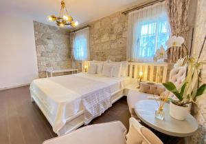 a bedroom with a large bed and a table and chairs at PROVENCE MANSİON ALAÇATI in Alacati