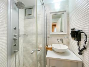 a bathroom with a sink and a shower at PROVENCE MANSİON ALAÇATI in Alacati