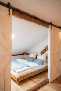 uma cama num quarto com uma porta de madeira em Ambiente & Comfort im historischen Anwesen em Walting
