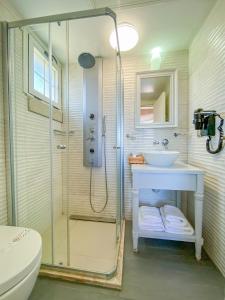 a bathroom with a shower and a sink and a toilet at PROVENCE MANSİON ALAÇATI in Alacati