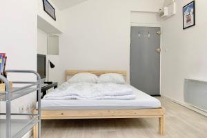 Bett mit weißer Bettwäsche in einem Zimmer in der Unterkunft Heart of Grenoble #BZ in Grenoble