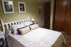 a bedroom with a large white bed with pillows at GaliciaGuestHome Avenida Vigo 62 in Pontevedra
