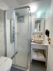 a bathroom with a shower and a sink at PROVENCE MANSİON ALAÇATI in Alacati