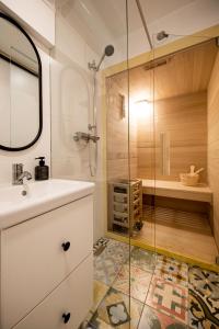 y baño con ducha, lavabo y cabina de ducha acristalada. en Lunela estate with sauna, en Cerklje na Gorenjskem