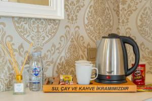 a kitchen counter with a coffee pot and a cup of milk at PROVENCE MANSİON ALAÇATI in Alacati