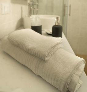 a white towel sitting on a counter in a bathroom at Affittacamere Le Pescatrici in Riomaggiore