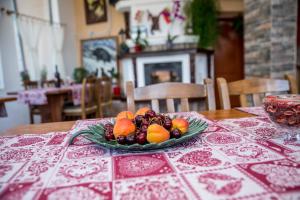a plate of fruit on top of a table at Семеен Хотел Свети Георги in Elena