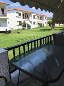 a table on a balcony with a view of a building at VILA ELENI FOURKA HALKIDIKI in Skala Fourkas