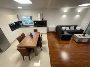 a living room with a table and a couch at Apartman Mihaljević in Opuzen