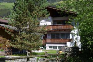 ein Gebäude mit einem Balkon und einem Zaun in der Unterkunft Appartement Nischler in Wald im Pinzgau