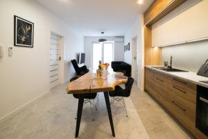 a kitchen with a wooden table in a room at Oxygen apartament nr 2 in Mielec +4 photos