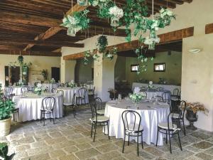 a banquet hall with white tables and chairs at Hotel Da Gigi in Santo Stino di Livenza