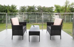 a patio with three chairs and a table on a patio at Oxygen apartament nr 2 in Mielec