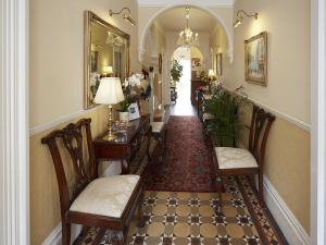 a hallway of a home with chairs and a hallwayngth at Somerville House in Hereford