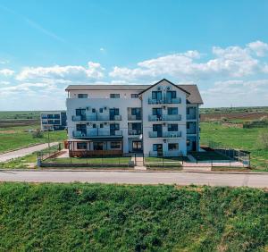 a large white building on the side of a road at Black Sea View Costinesti in Costinesti