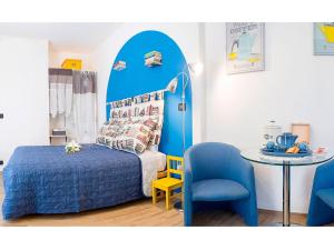 a bedroom with a blue bed and a table at B&Biscuit in Turin