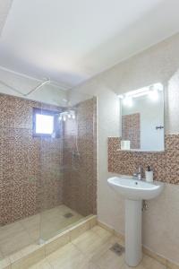 a bathroom with a sink and a shower with a mirror at Black Sea View Costinesti in Costinesti +56 photos