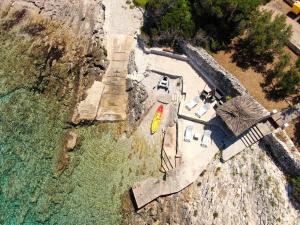 an aerial view of a beach with a house and the water at Stone House Blaca in Blato