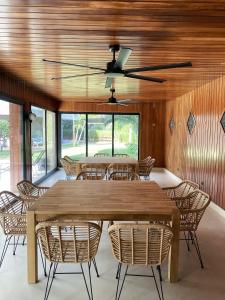 a dining room with a large wooden table and chairs at Los Globos Beach Studio by Hello Homes Sitges in Sitges
