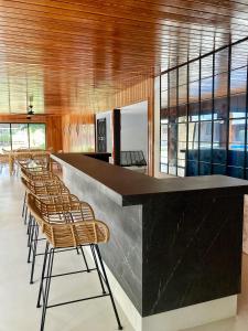 a bar with a row of chairs in a room at Los Globos Beach Studio by Hello Homes Sitges in Sitges