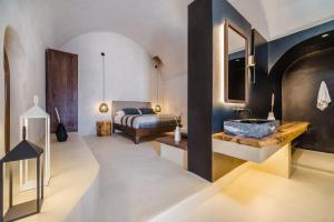 a bathroom with a sink and a bed in a room at Phaos 1870, A restored Winery in Pirgos