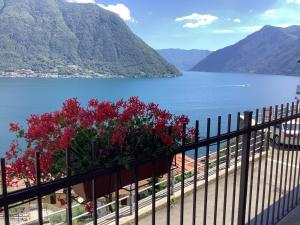 a balcony with a view of a lake and mountains at Colonno Panoramica Lago Di Como in Colonno +61 photos
