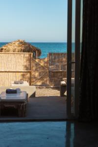 a room with a view of the ocean from a beach at Demilmar Luxury Suites in Perissa