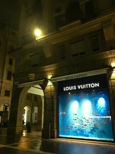 un grande cartello di fronte a un edificio di notte di SAVOIA ROOMS a Padova